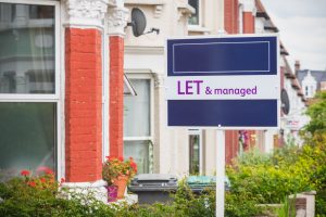 Let and managed sign displayed outside a terraced house 